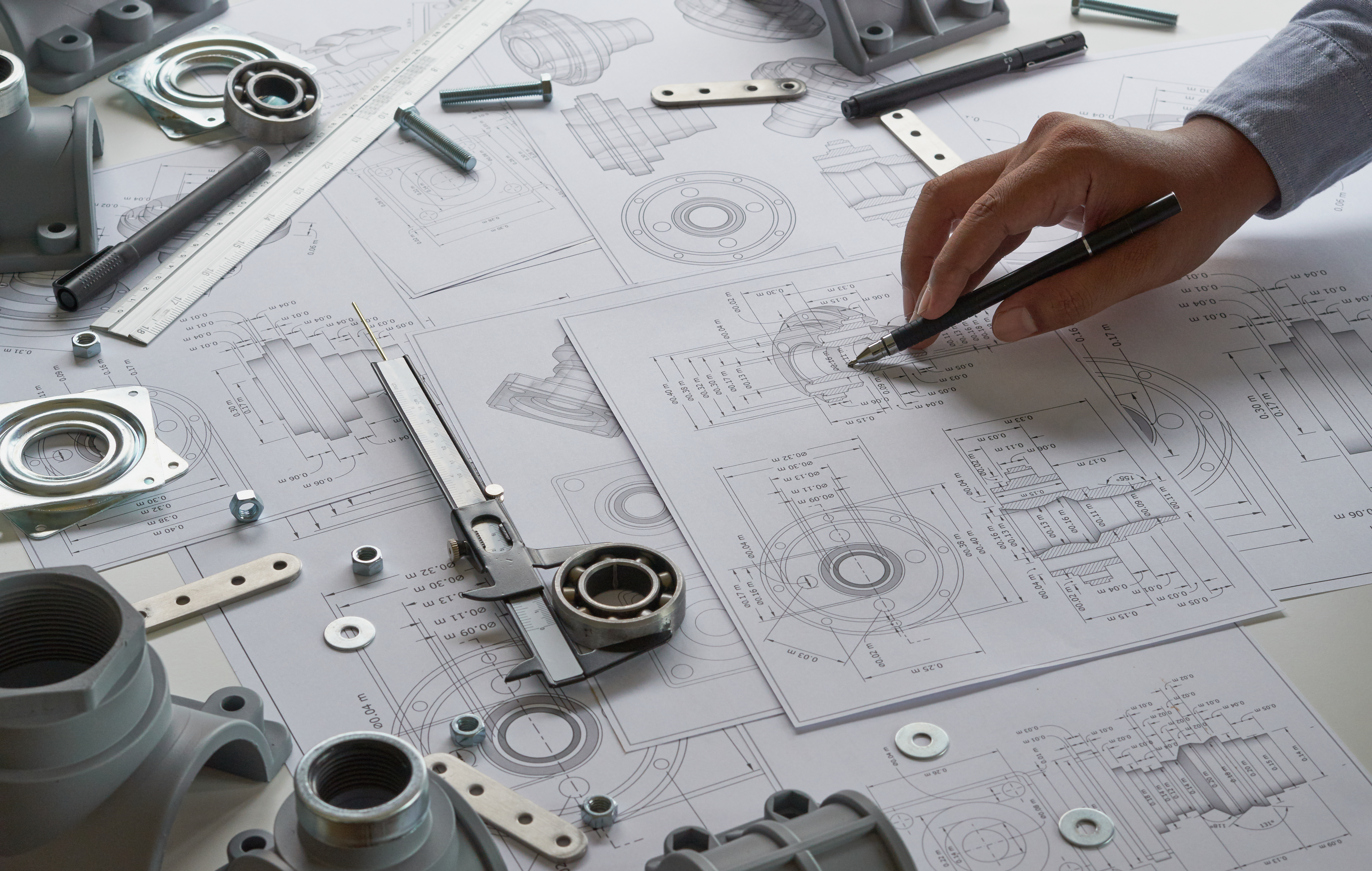 Engineer technician designing drawings mechanical parts engineering Enginemanufacturing factory Industry Industrial work project blueprints measuring bearings caliper tools