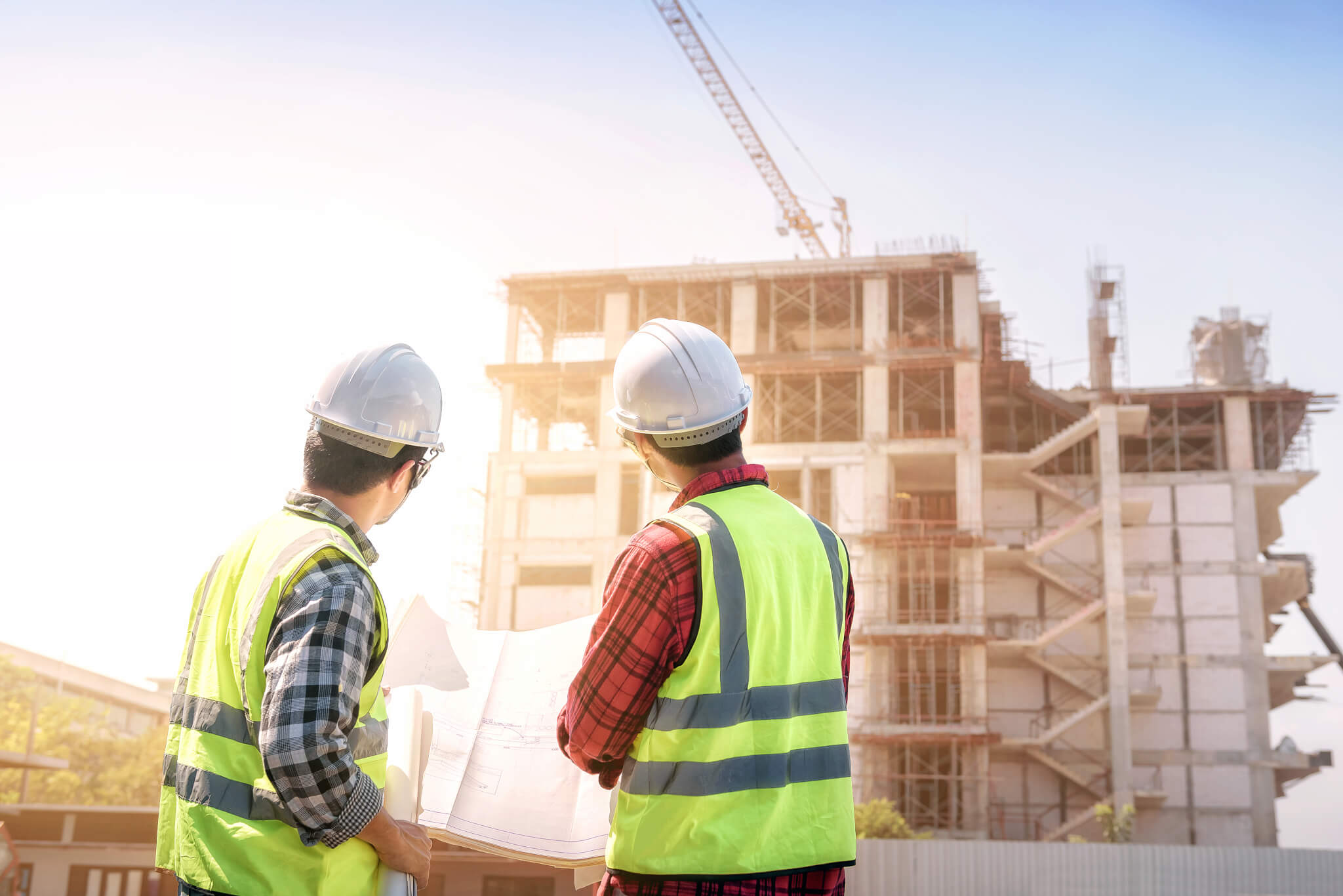 engineers discussion with consultants about detail of building at construction site.