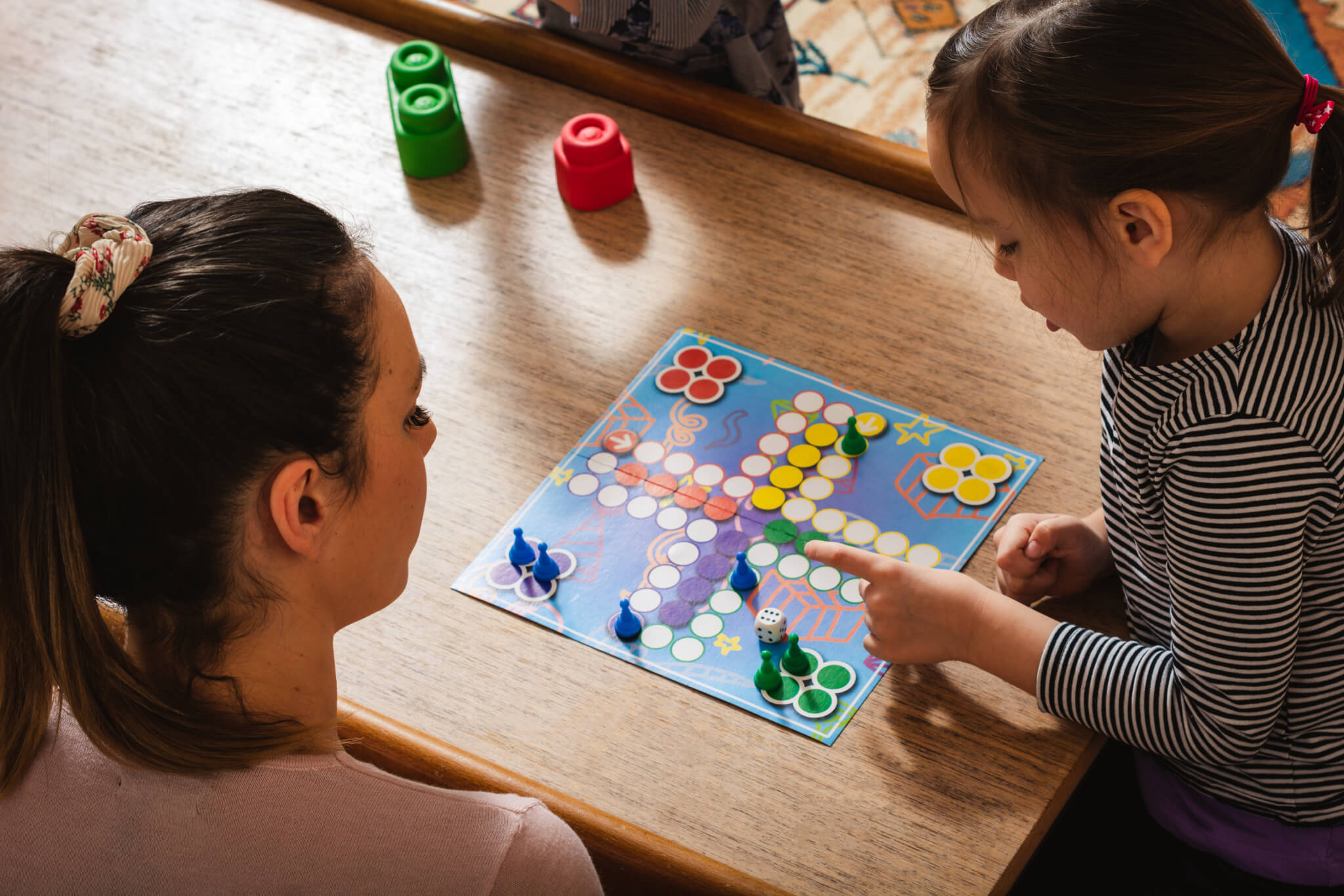 Family playing board game at home.